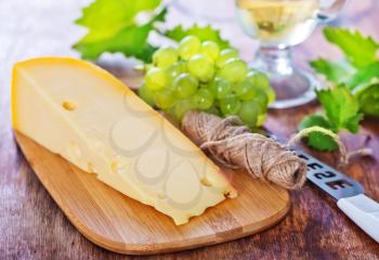 cheese and grape on the wooden table