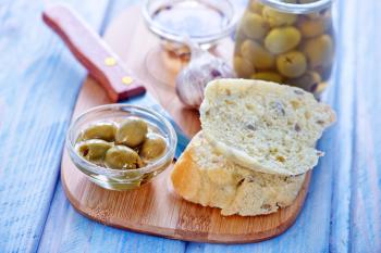 bread with olive and oil on the board