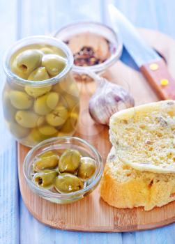 bread with olive and oil on the board