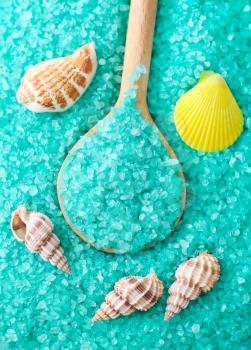 Blue sea salt in spoon and seashell