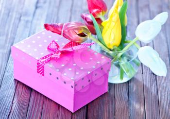tulipsand box for present on the wooden table, spring flowers
