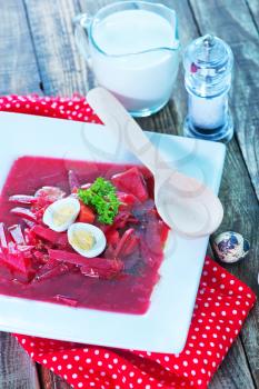 beet soup in bowl and on a table
