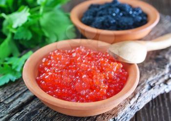 black and red caviar in bowls and on a table