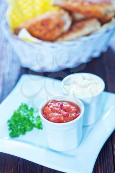 fast food on the wooden table, chicken with sauce