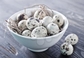 quail eggs in the bowl and on a table