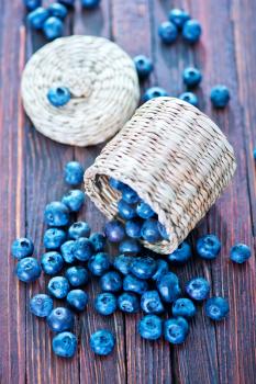 fresh blueberry on the wooden table, blueberry in basket