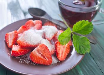 fresh strawberry with sugar on the plate