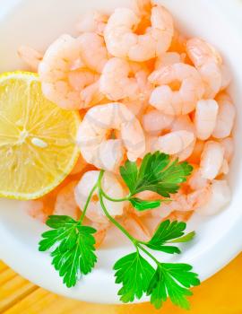 boiled shrimps in the white bowl on the table