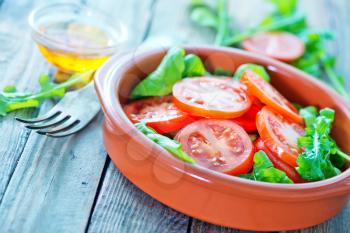 salad with fresh rucola and tomato in bowl
