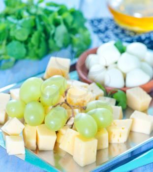 cheese cubes and grape on metal tray