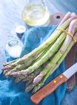 green asparagus, raw asparagus on the wooden table