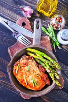 fried meat with asparagus in the pan