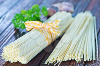 raw pasta on wooden board, raw spaghetty