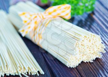 raw pasta on wooden board, raw spaghetty