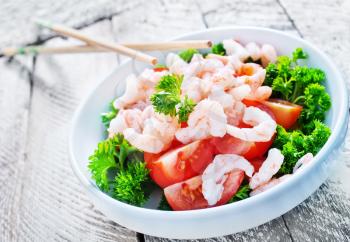 salad with shrimps in bowls and on a table
