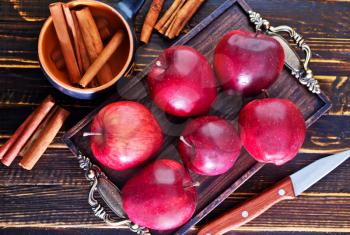 apples and cinnamon on the wooden table