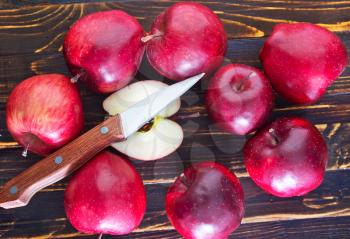 fresh apples and knife on the wooden table