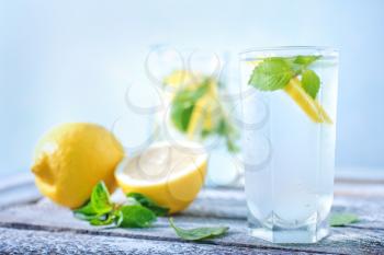fresh lemonad in glass and on a table