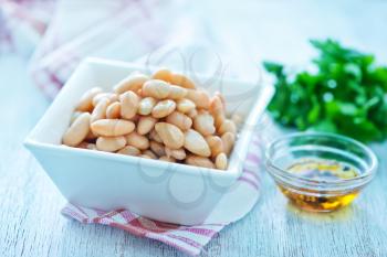 white beans in bowl and on a table