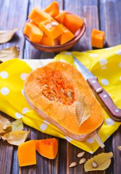 fresh pumpkin on the wooden table, autumn harvest of pumpkin