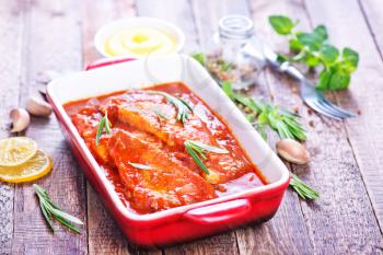 fish with sauce in bowl and on a table