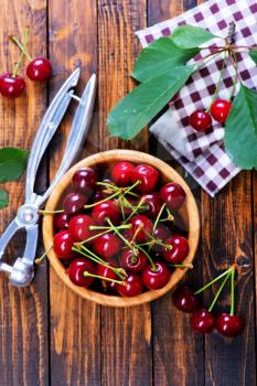 fresh cherry in bowl and on a table