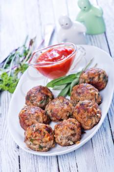 fried meat balls with sauce and spice on the plate