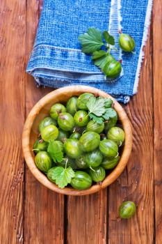 fresh gooseberry in bowl and on a table