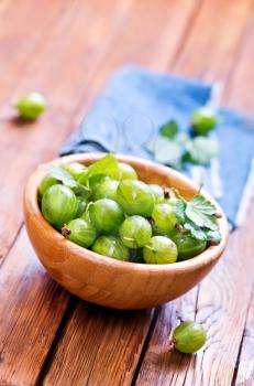 fresh gooseberry in bowl and on a table