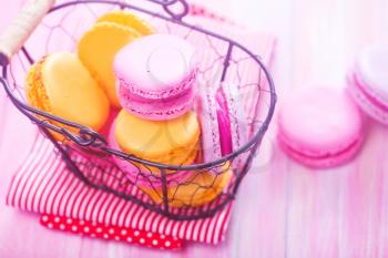 color macaroons in basket and on a table