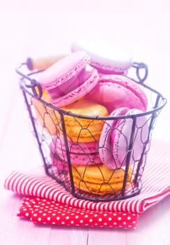 color macaroons in basket and on a table