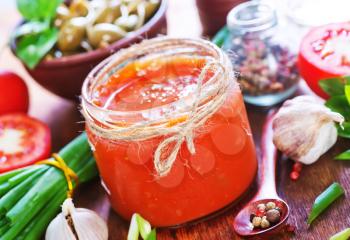 salsa in glass bank and on a table