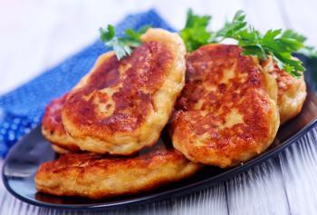 cutlets on black plate and on a table
