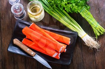 crab sticks on plate and on a table