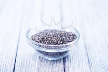 chia seeds in glass bowl and on a table
