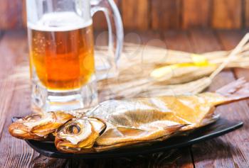 smoked fish on plate and on a table