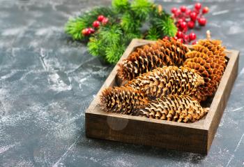 christmas decoration, cones and branch on a table