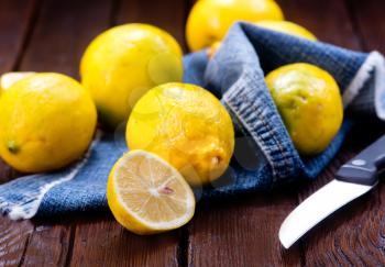 fresh yellow lemons on the wooden table