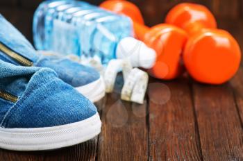 sport shoes and water on the wooden table