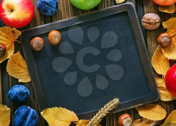 autumn harvest and chalkboard for note on a table