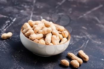 peanuts in bowl and on a table