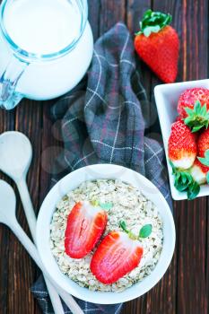 raw oat flakes in the white bowl