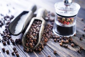 black pepper and white salt on  a table