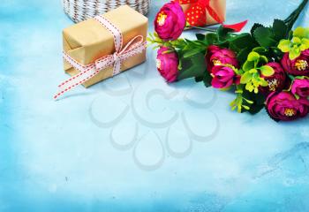 present and flowers on the blue background