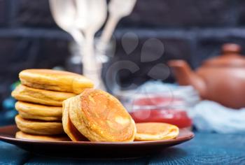 fresh pancakes on plate and on a table