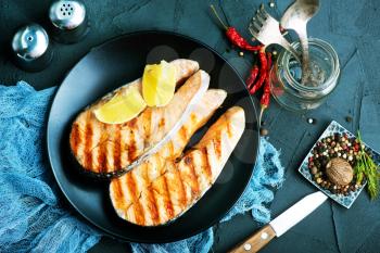 fried fish on plate and on a table