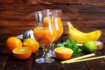 orange juice in glasses and on a table