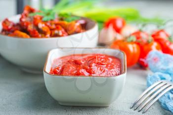 dry tomato,fresh tomato and sauce on a table