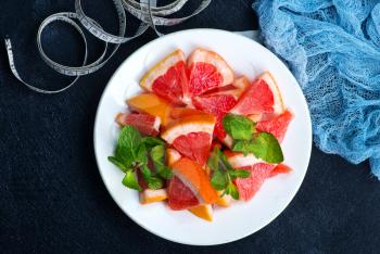 fresh grapefruit on plate and on a table
