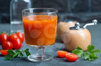 tomato juice in glass and vodka on a table